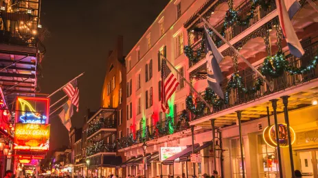New orleans french quarter at night, lit up with Christmas decorations and christmas garlands