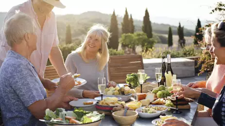 group of travellers in tuscany enjoying a meal