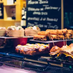 Several trays presented with a variety of Spanish tapas on the bar counter