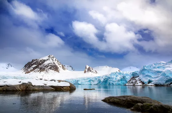 Mountains, snow and blue glacial ice in Svalbard