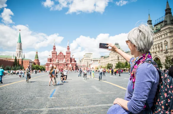 Portrait of a mature woman photographing Red Square in Moscow, Russia.