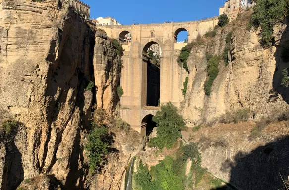 Village Ronda sitting on rocky clifftops and Puente Nuevo, a bridge in Ronda in Andalusia, Spain.