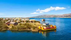 The floating islands on Titicaca Lake, featuring moored kayaks and wooden cabins