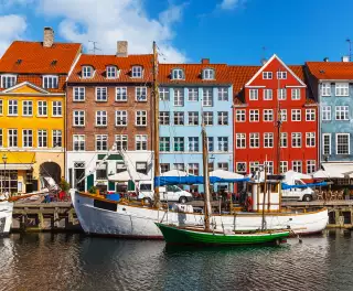 Colourful row of houses and canal with boats in Copenhagen, Denmark