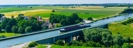 Ship sailing along bridge on the Rhine–Main–Danube Canal in Bavaria, Germany